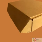Open kraft box with shredded paper filler and small bottles inside