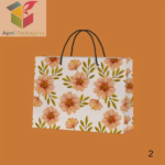 Floral printed paper gift bag with black rope handles by Apni Packaging