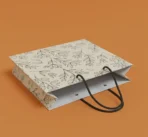 Botanical leaf print paper shopping bag with black rope handles