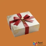 Luxury rigid gift box with red ribbon and gold foil detailing by Apni Packaging